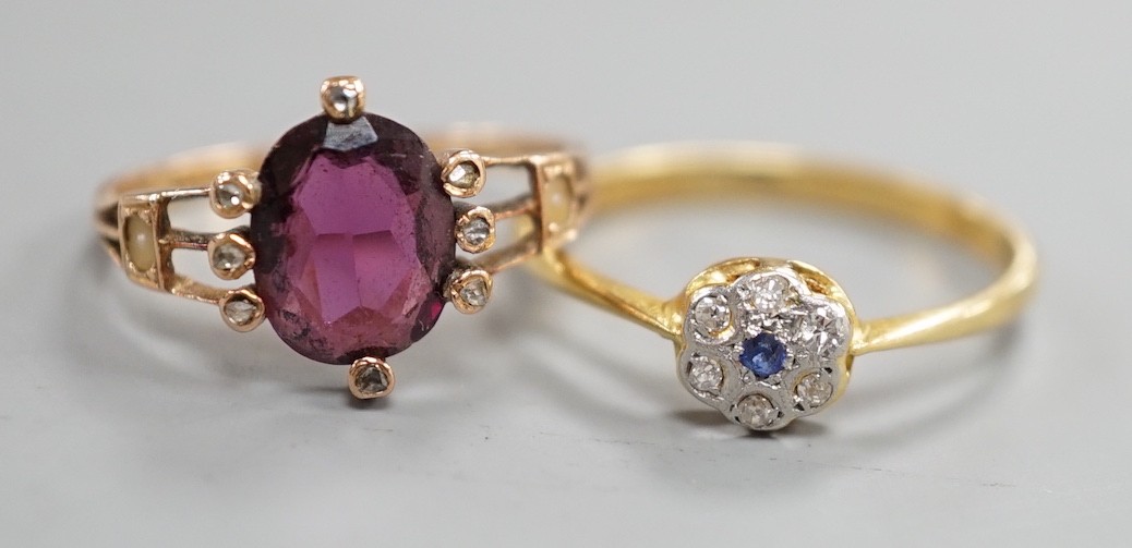 A small 1920's 18ct, sapphire and diamond cluster set flower head ring, size P/Q, gross weight 2.3 grams and a yellow metal, garnet?, split pearl and diamond chip set oval cluster ring, gross weight 2 grams.